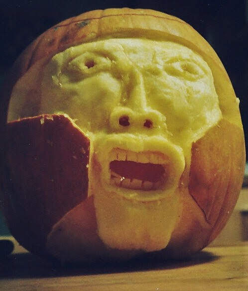 Pumpkin carved Halloween 2000 as a screaming knight inside his armor, a self-portrait of the physician role holding while the person inside is not.