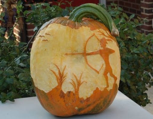 Pumpkin carved 2010, archer at sunset in the mountains, lit from the front showing the foreground carving.