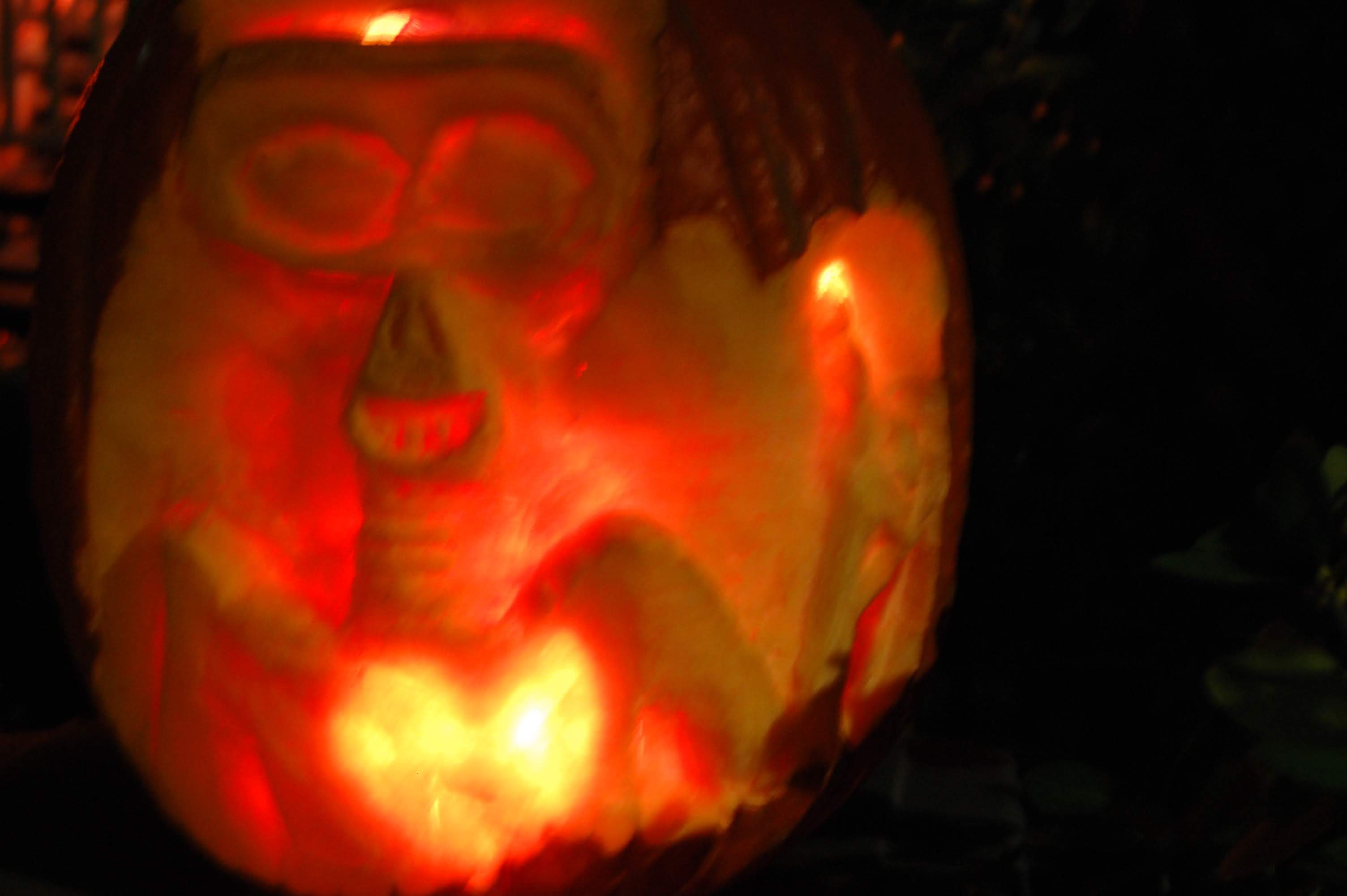 Pumpkin carved 2011 as the resuscitation scene from ET, the Extraterrestrial &mdash; a joyful ET with his glowing heart at the moment his alien brothers arrive.