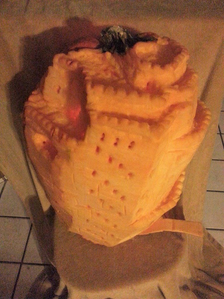 Pumpkin carved 2013 as Minas Morgul, the tower from Tolkien, with hidden interior architecture &mdash; stairwells, walkways, and an orange-glowing army inside the windows.