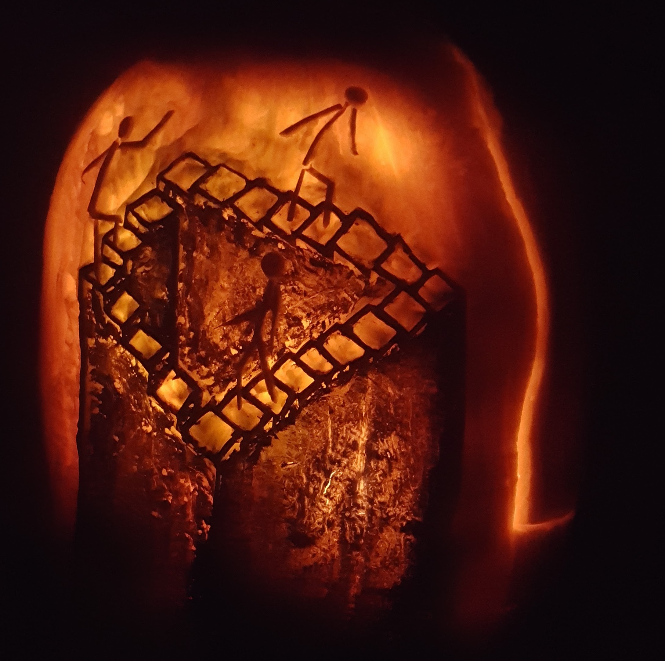 Pumpkin carved 2017 as an Escher-style endless staircase of monks, with color used to render the third dimension.