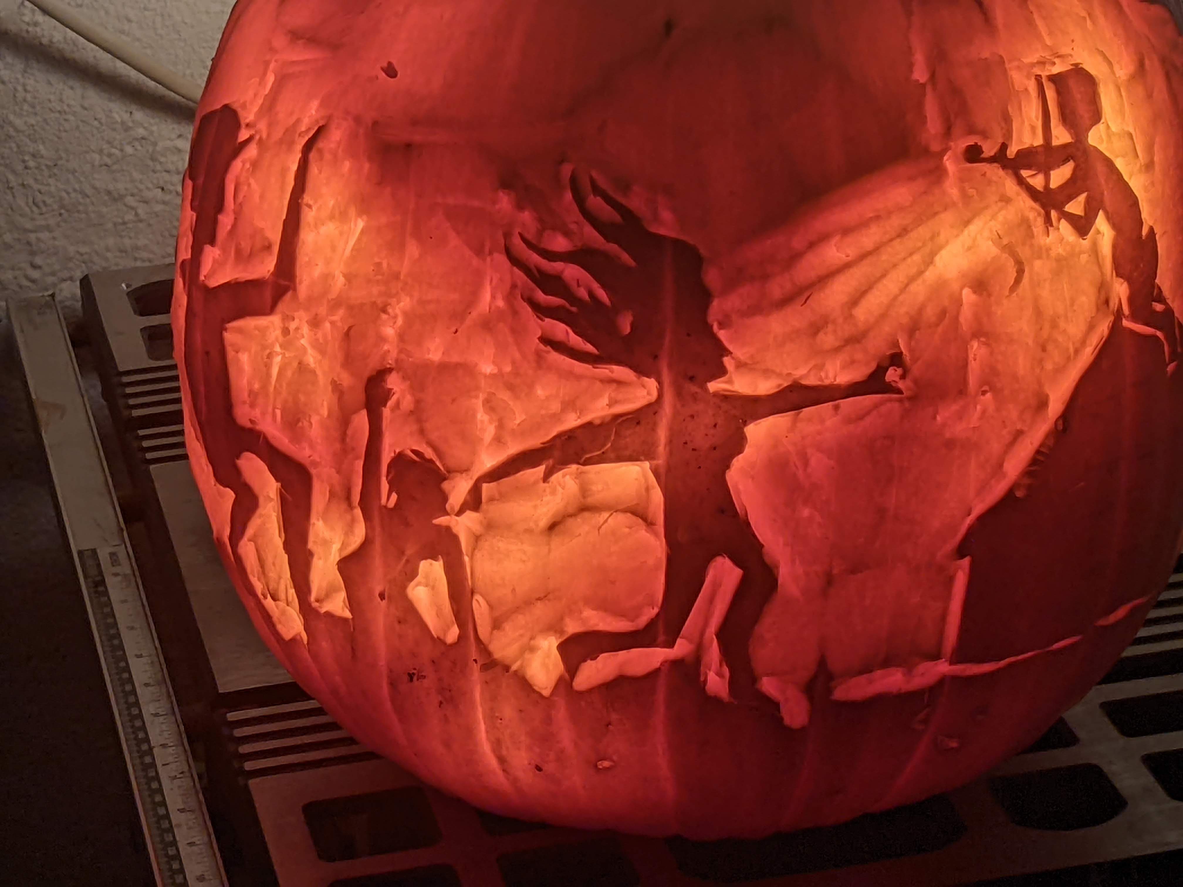 Pumpkin carved 2022 as a fiddler perched on a roof, vibrant and layered, the music almost audible.