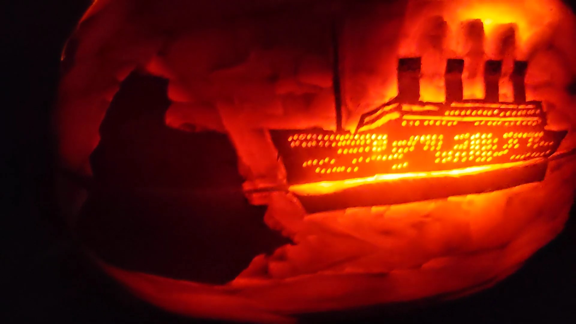 Pumpkin carved 2023 as fumes from the Titanic wrapping the world in a glowing embrace &mdash; coal dust as a tragedy with lessons not yet learned.